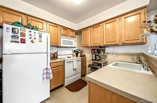 a kitchen with a refrigerator a sink and cabinets