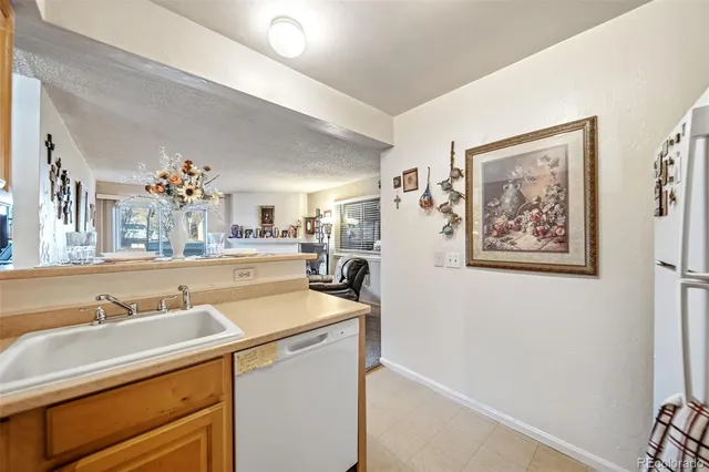 a view of a hallway with bathroom and mirror