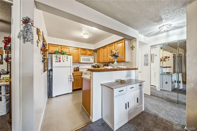 a kitchen with white cabinets and white appliances