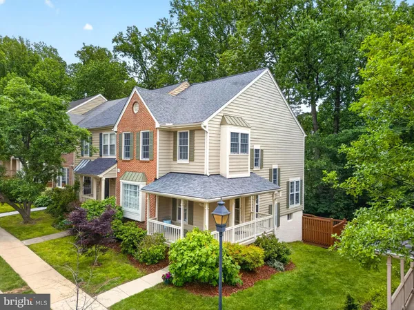a front view of a house with a yard and potted plants