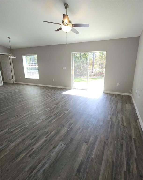 6312 Southwest 134th Loop Ocala, FL 34473 - Photo 5 of 13 wooden floor in an empty room with a window