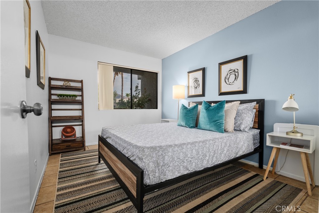 69646 Antonia Way Rancho Mirage, CA 92270 - Photo 30 of 50 a bedroom with a bed and wooden floor