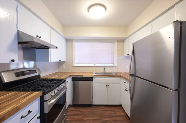 a kitchen with a sink stove and refrigerator