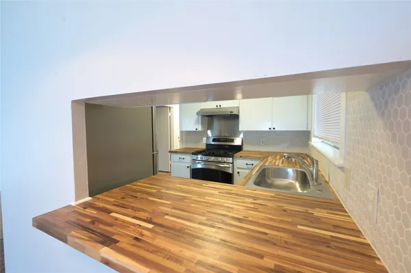 a kitchen with a refrigerator stove and a sink