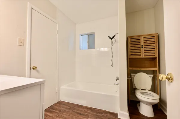 a bathroom with a toilet and a bathtub