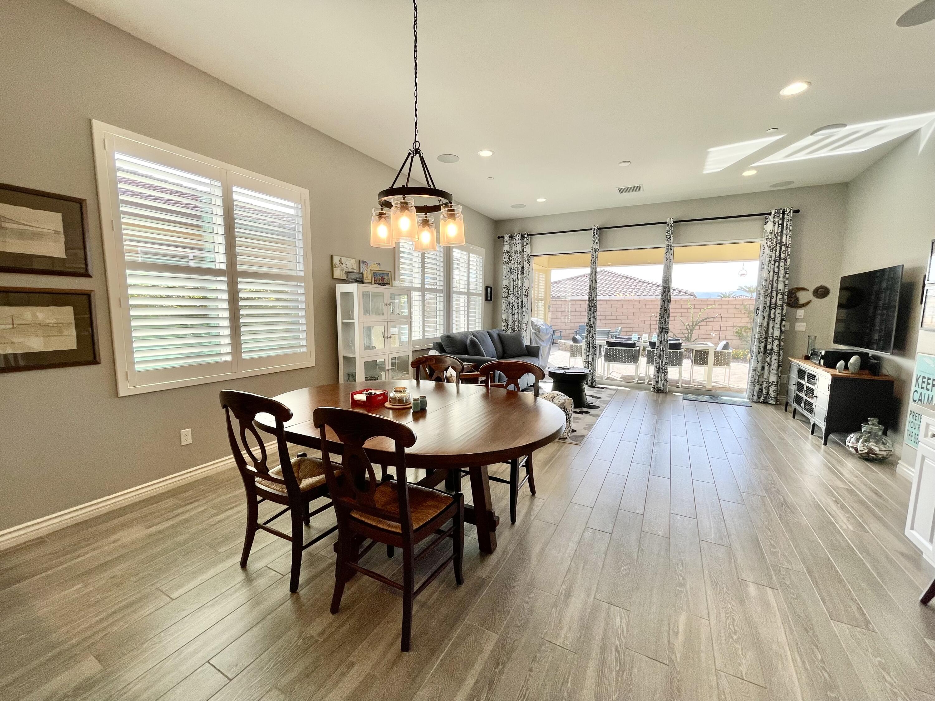 43573 Adria Drive Indio, CA 92203 - Photo 17 of 63 a view of a dining room with furniture window and wooden floor