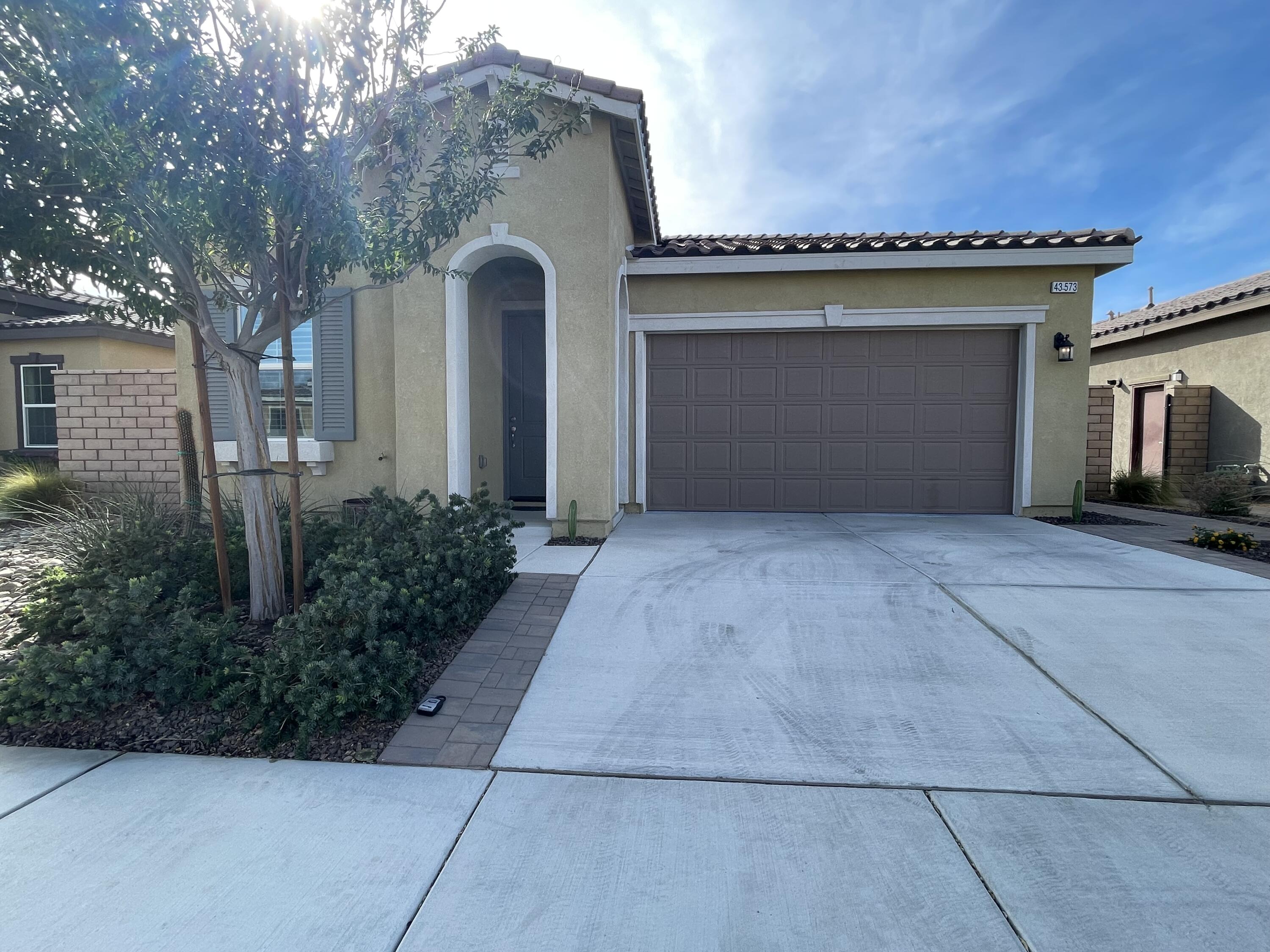 43573 Adria Drive Indio, CA 92203 - Photo 2 of 63 a front view of a house with garage