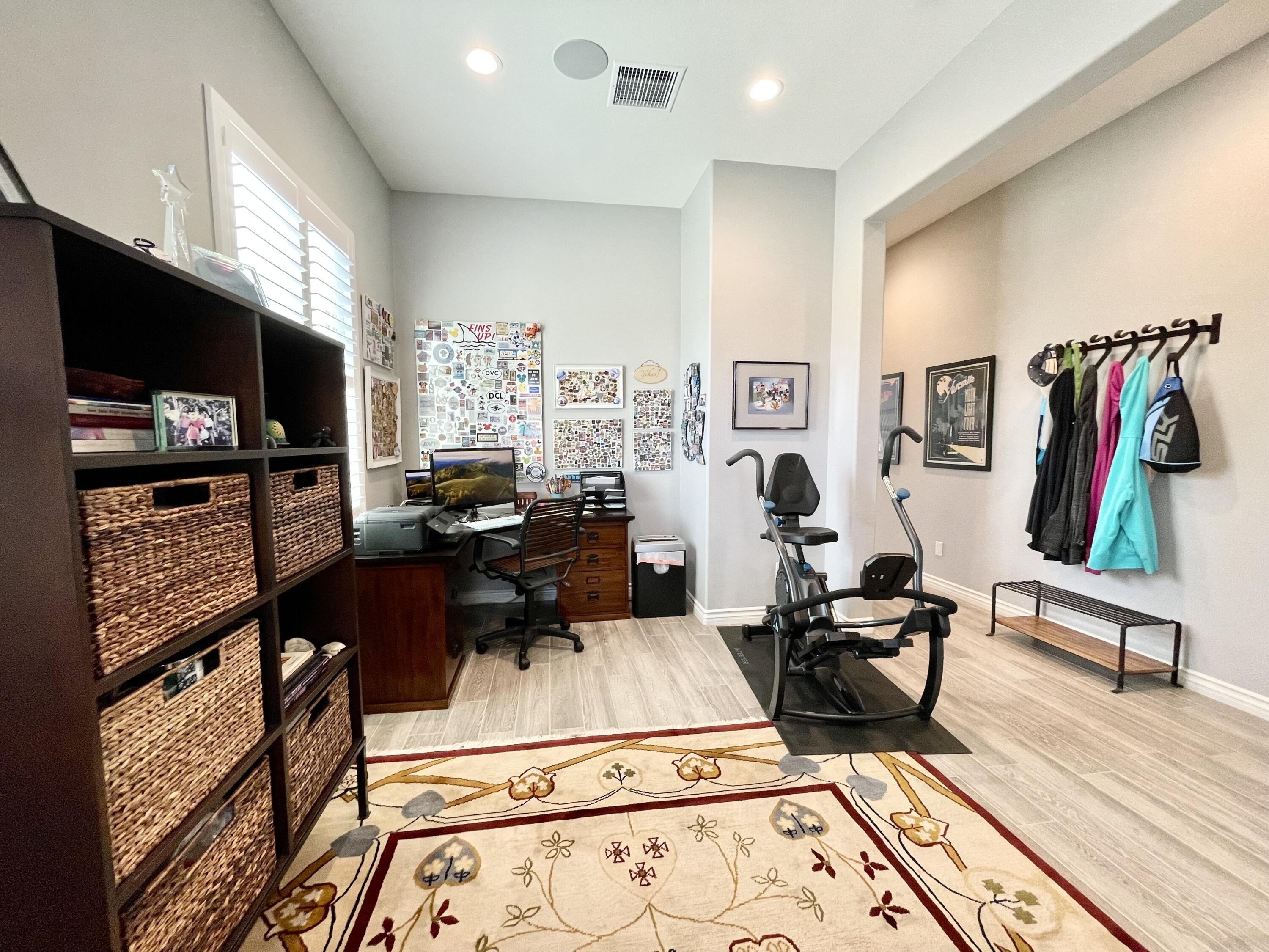 43573 Adria Drive Indio, CA 92203 - Photo 29 of 63 a living room with furniture gym equipment and a flat screen tv