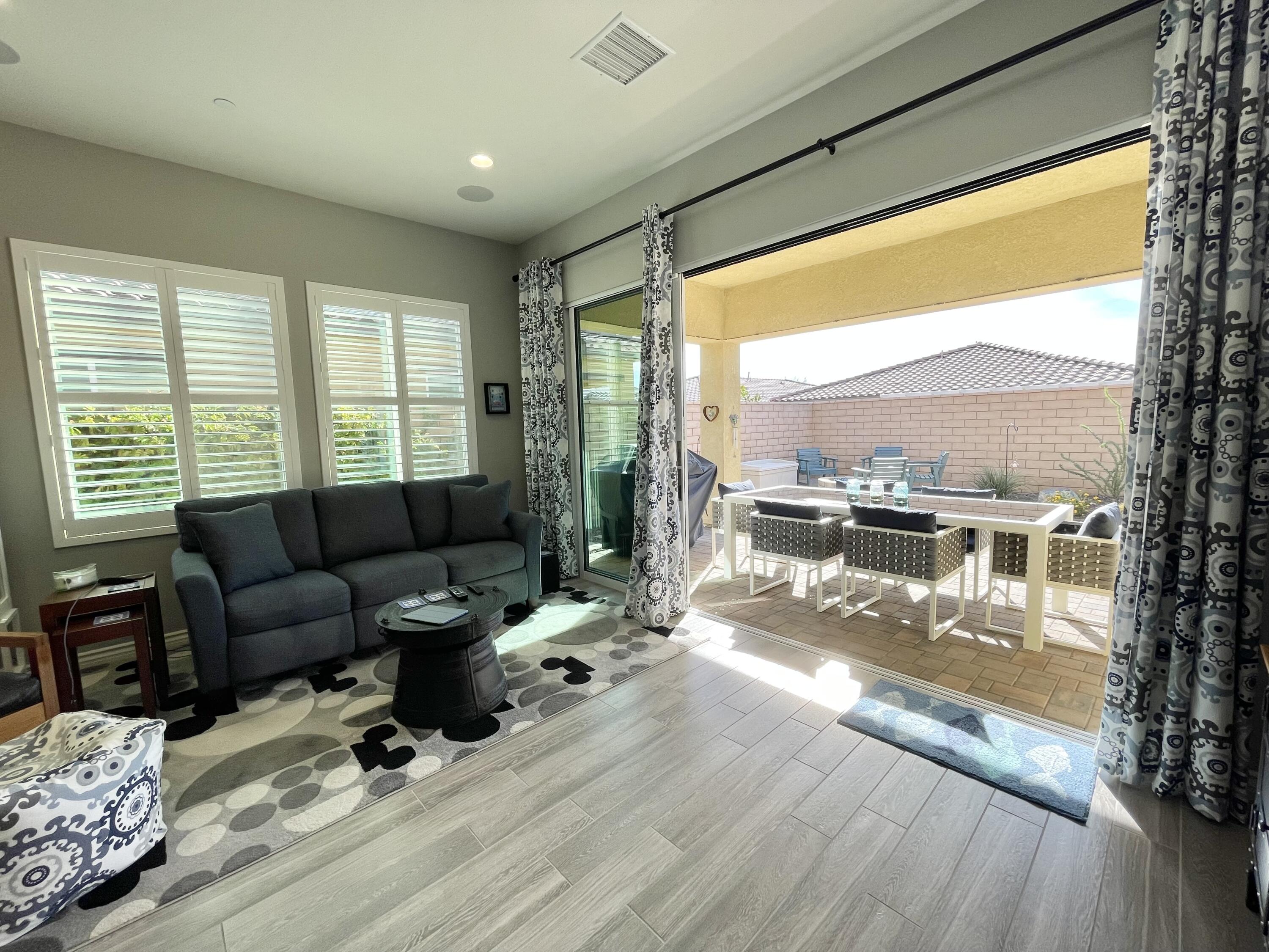 43573 Adria Drive Indio, CA 92203 - Photo 32 of 63 a living room with furniture and a large window
