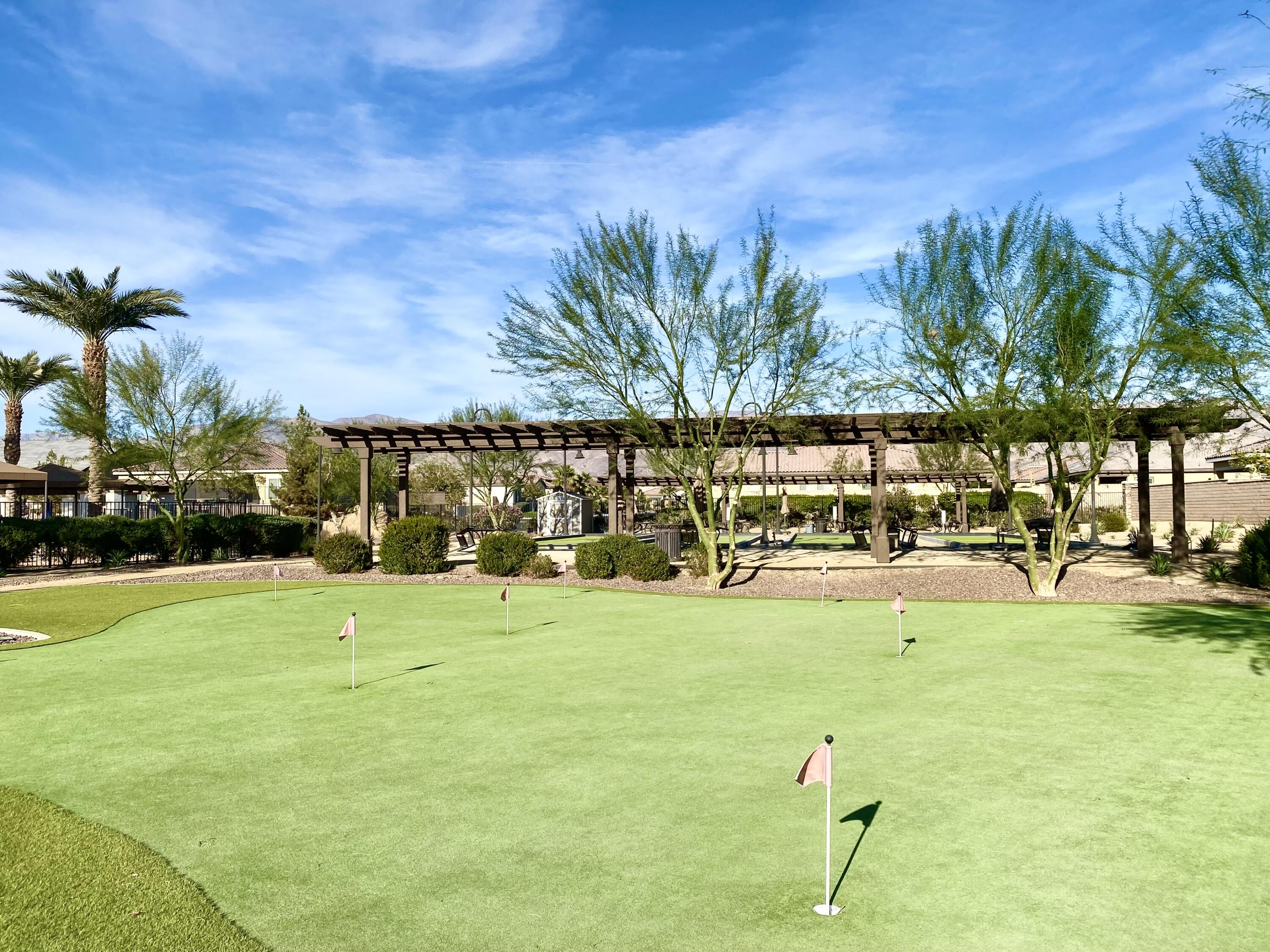 43573 Adria Drive Indio, CA 92203 - Photo 61 of 63 a view of a swimming pool with an outdoor seating and a yard
