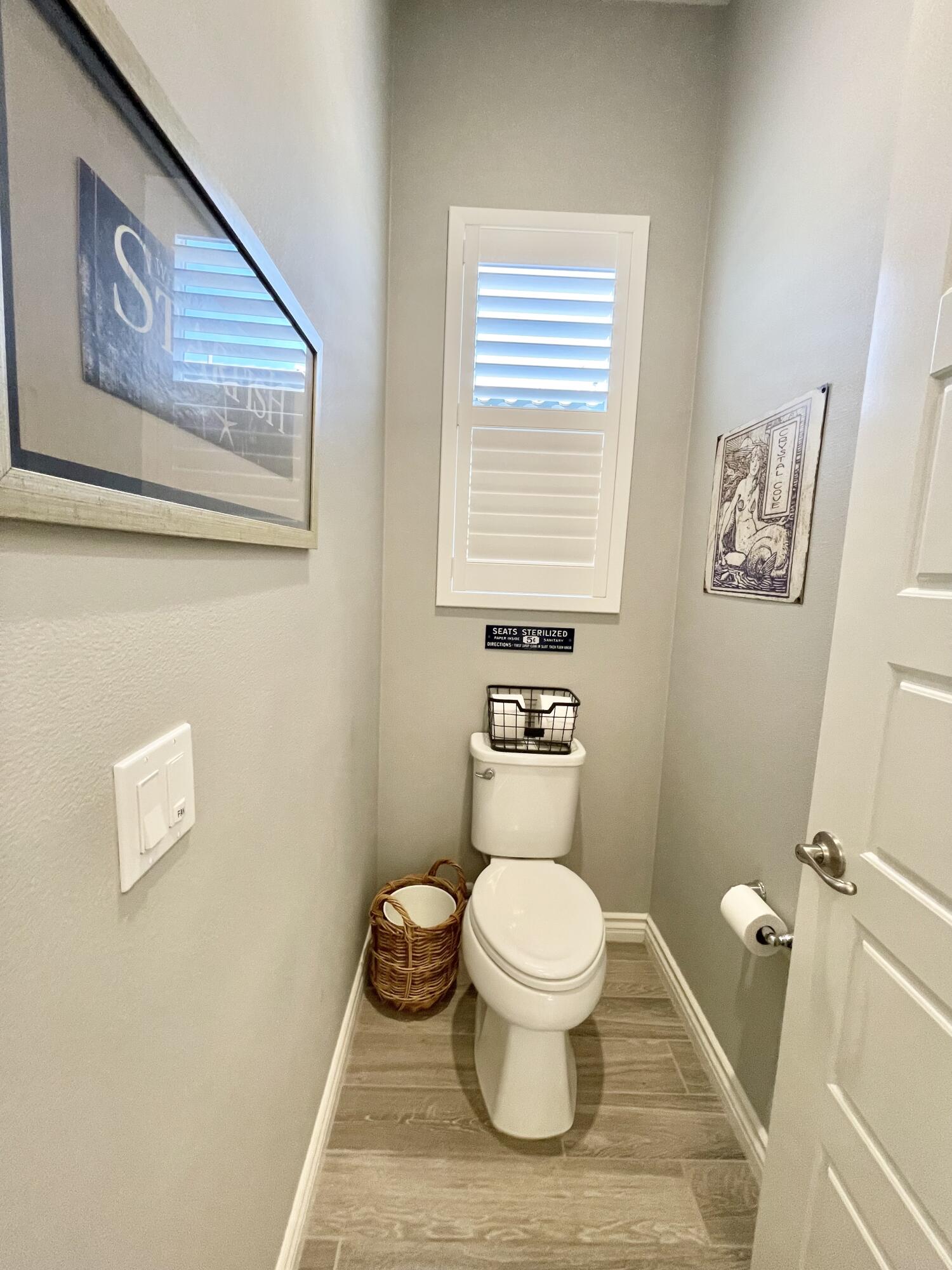 43573 Adria Drive Indio, CA 92203 - Photo 9 of 63 a white toilet sitting next to a bathroom sink