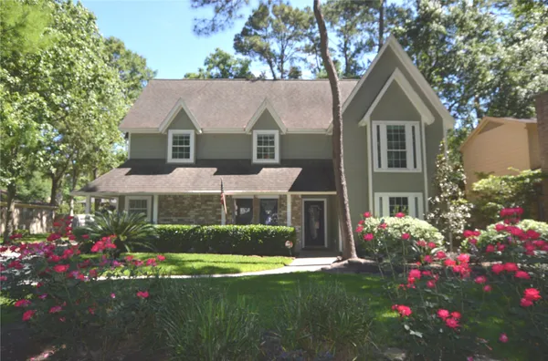 a front view of a house with a yard and fountain