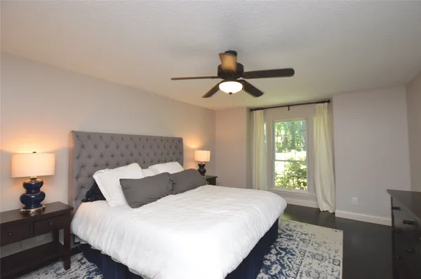 a bedroom with a large bed and a chandelier