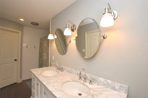 a bathroom with a sink vanity and a mirror