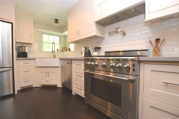 a stove top oven sitting inside of a kitchen