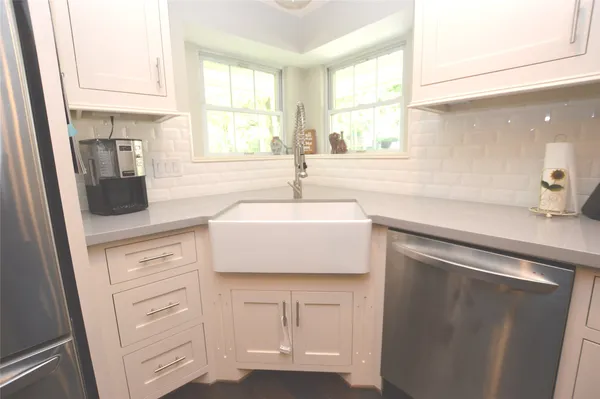 a kitchen with cabinets appliances and a sink