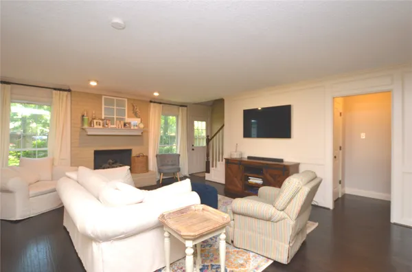 a living room with furniture a fireplace and a flat screen tv