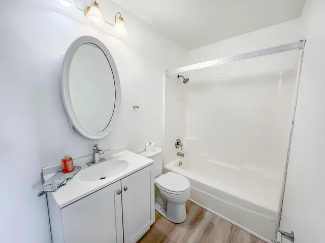 a bathroom with a sink a toilet and a mirror