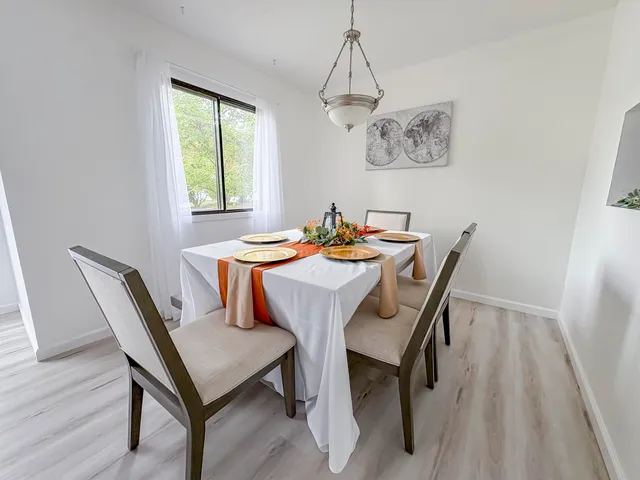 a view of a dining room with furniture window and wooden floor