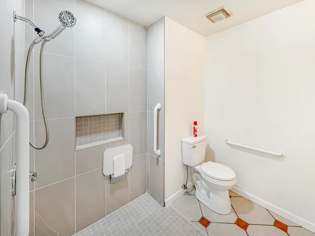 a bathroom with a toilet and a shower