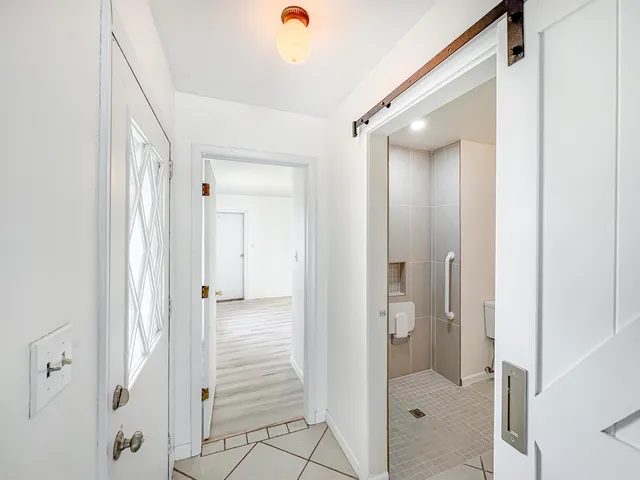 a view of a bathroom from a hallway