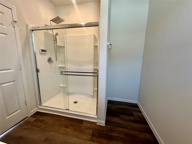 an empty room with closet and a chandelier fan