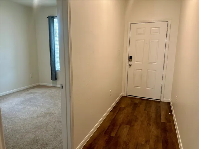 an empty room with wooden floor and closet