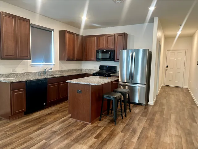 a kitchen with a sink appliances and cabinets
