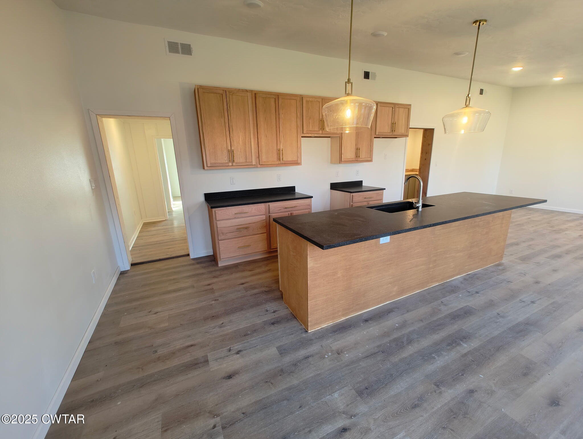 49 Primrose Drive Jackson, TN 38305 - Photo 12 of 20 a kitchen with kitchen island a sink and wooden floor