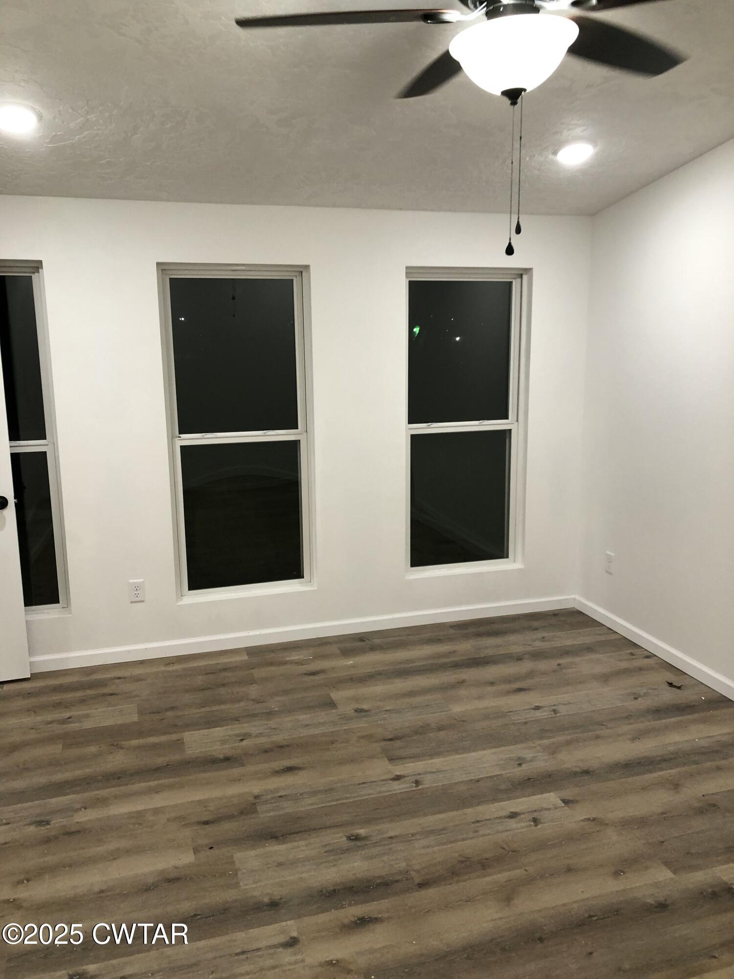 49 Primrose Drive Jackson, TN 38305 - Photo 16 of 20 a view of an empty room with wooden floor