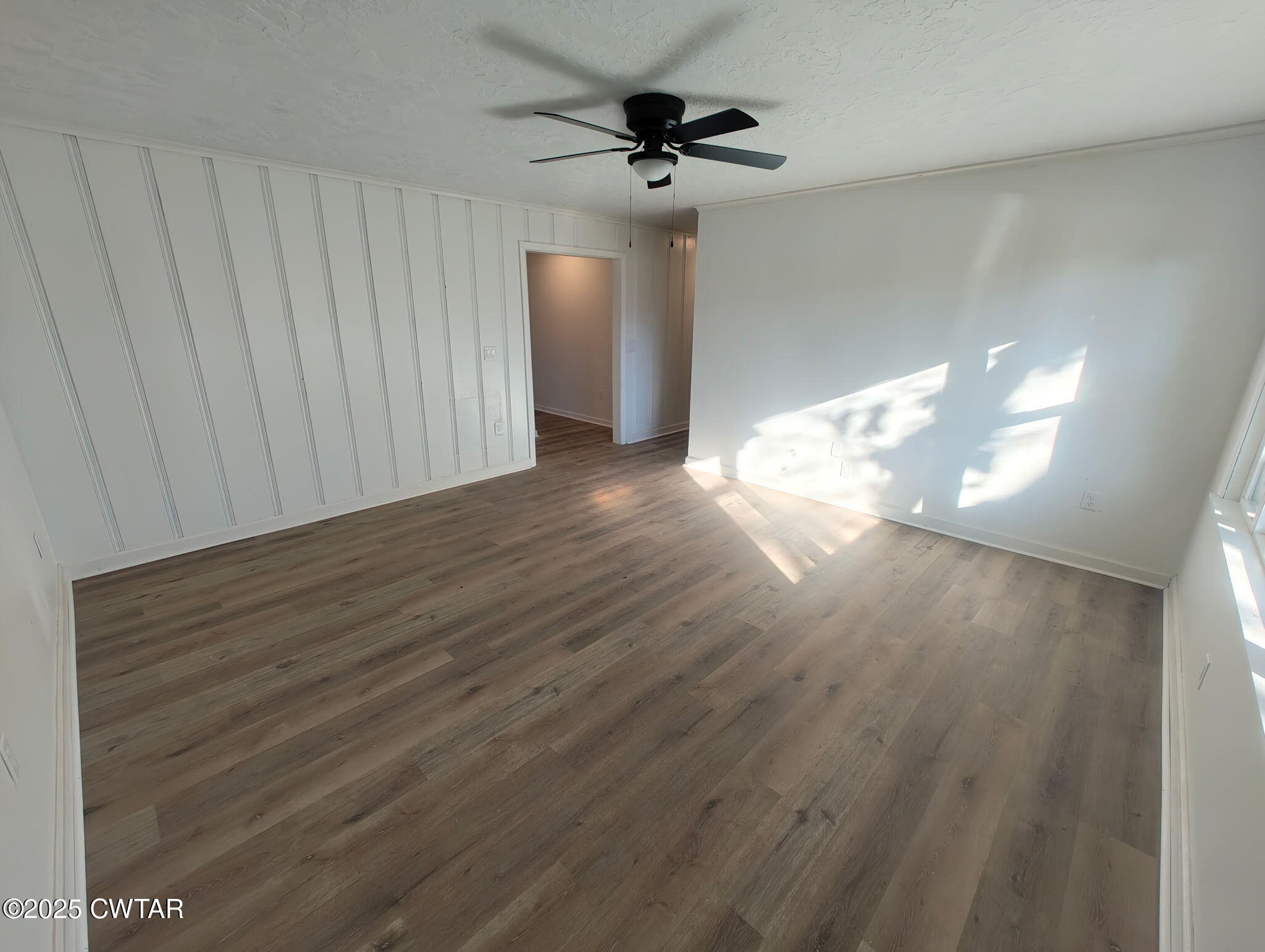 49 Primrose Drive Jackson, TN 38305 - Photo 3 of 20 a view of a livingroom with wooden floor and a ceiling fan