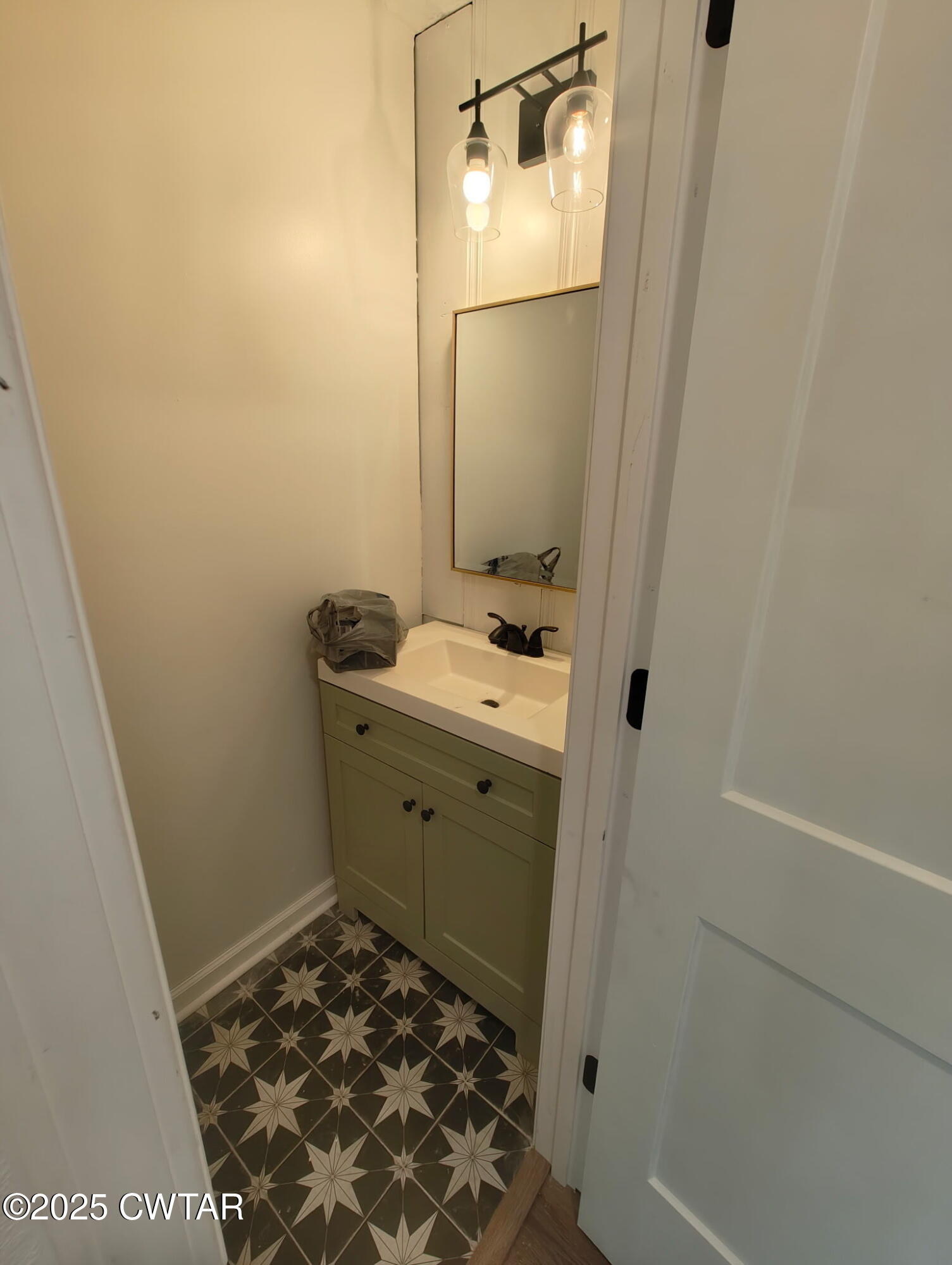 49 Primrose Drive Jackson, TN 38305 - Photo 9 of 20 a bathroom with a sink and a mirror