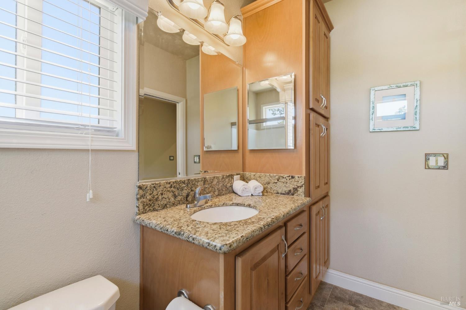 120 Shamrock Circle Santa Rosa, CA 95403 - Photo 27 of 45 a bathroom with a granite countertop sink a toilet and a mirror