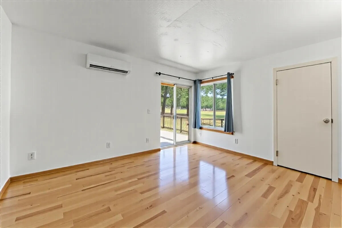 13185 Montecito Road Red Bluff, CA 96080 - Photo 11 of 36 a view of an empty room with wooden floor and a window