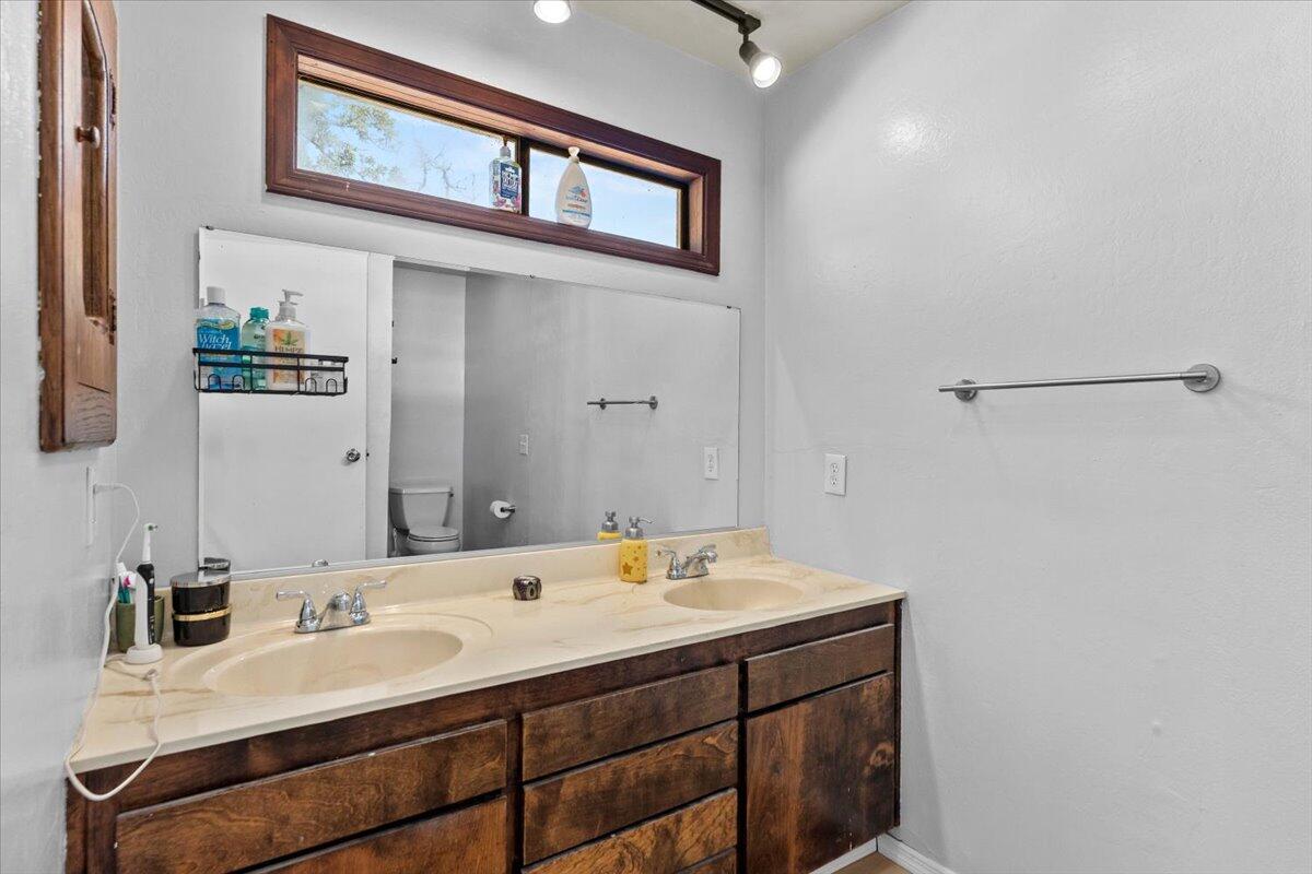 13185 Montecito Road Red Bluff, CA 96080 - Photo 12 of 36 a bathroom with a sink and a mirror