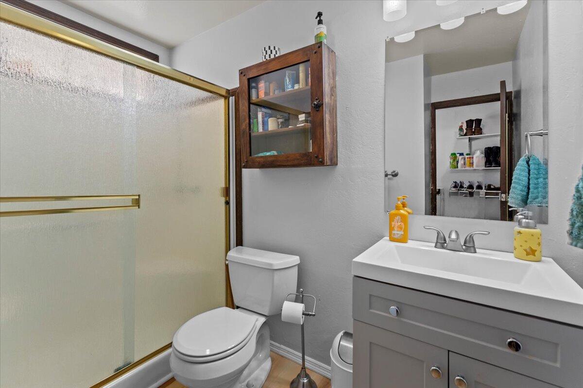 13185 Montecito Road Red Bluff, CA 96080 - Photo 18 of 36 a bathroom with a sink mirror vanity and toilet