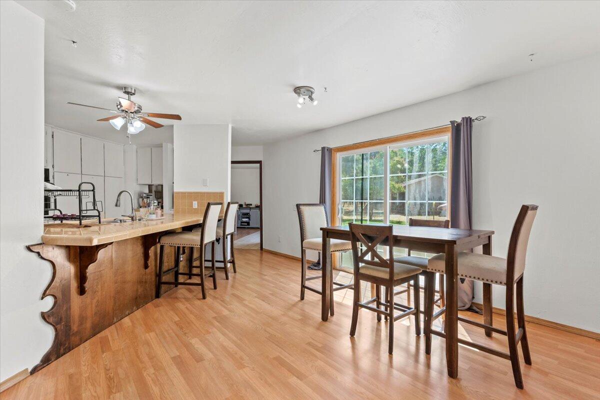 13185 Montecito Road Red Bluff, CA 96080 - Photo 7 of 36 a view of a a dining room with furniture window and wooden floor