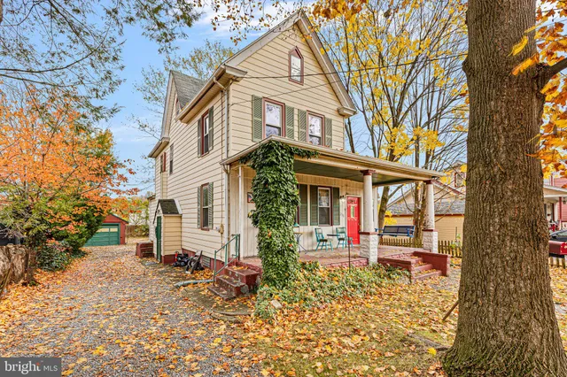 front view of a house with a large tree