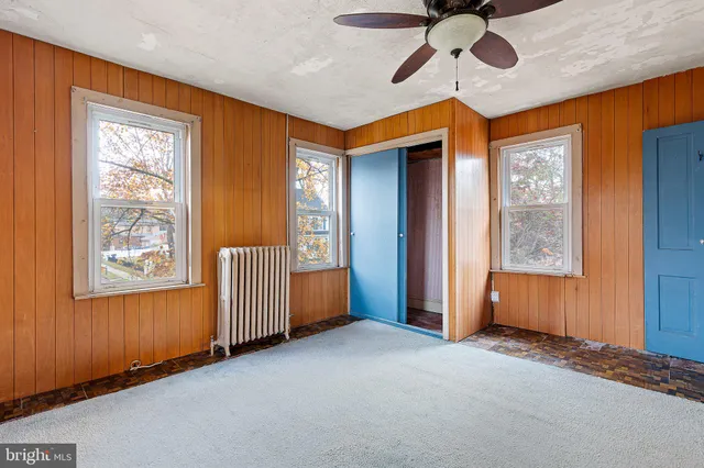 a view of an empty room and a window