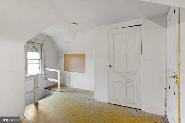 a spacious bedroom with a bed and a view of bathroom