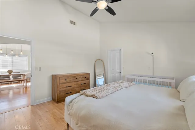 a bedroom with a bed and wooden floor