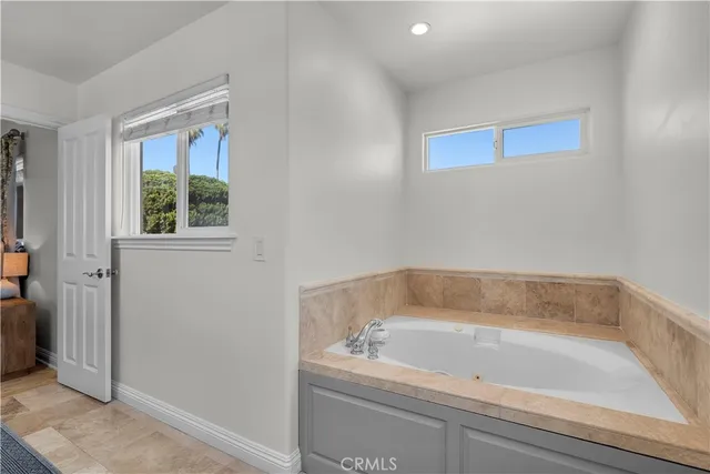a white bath tub sitting next to a window