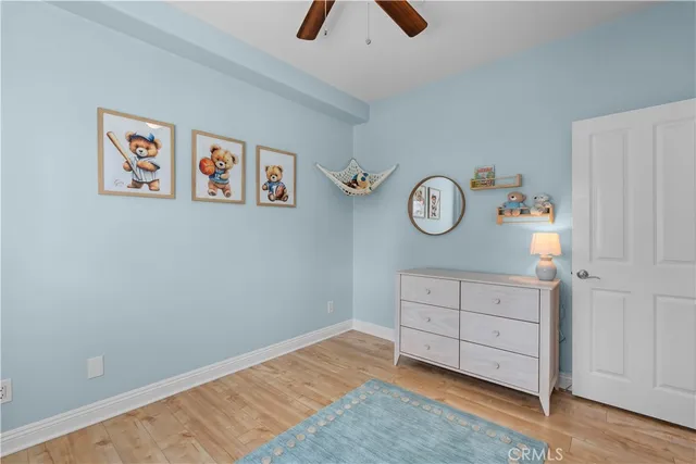 an empty room with a cabinet and a wall painting