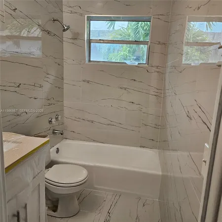 a bathroom with a toilet a sink and a bathtub