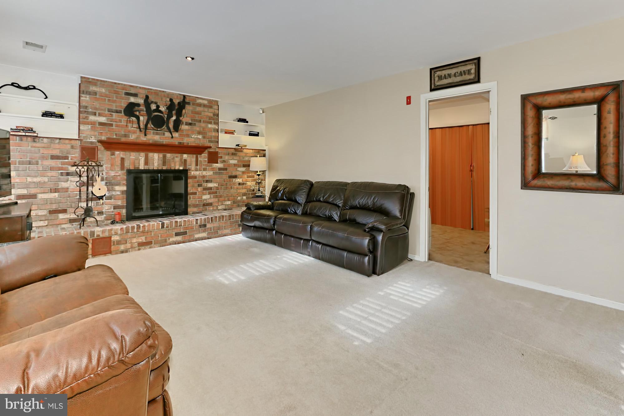 2340 Archdale Road Reston, VA 20191 - Photo 20 of 30 a living room with furniture and a fireplace
