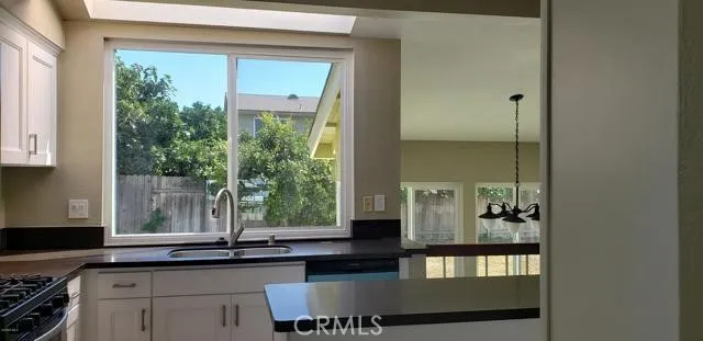 a kitchen with a window a sink and a counter