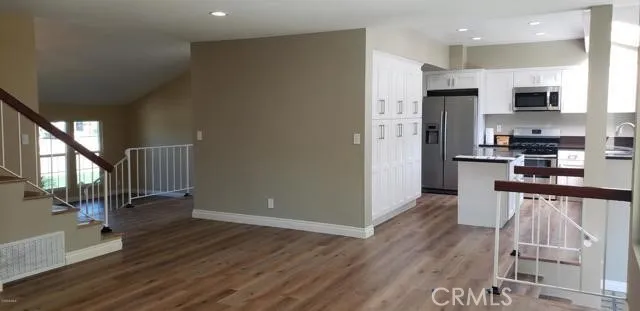 a kitchen with stainless steel appliances a refrigerator and a stove top oven