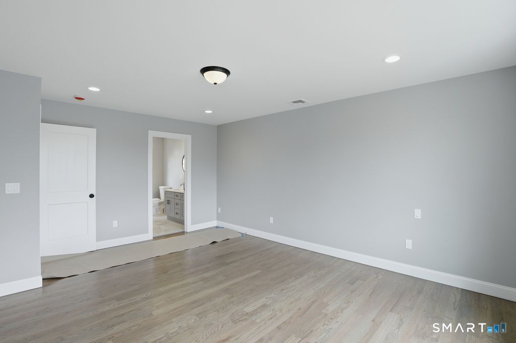 796 Maple Hill Road Naugatuck, CT 06770 - Photo 23 of 35 an empty room with wooden floor and windows