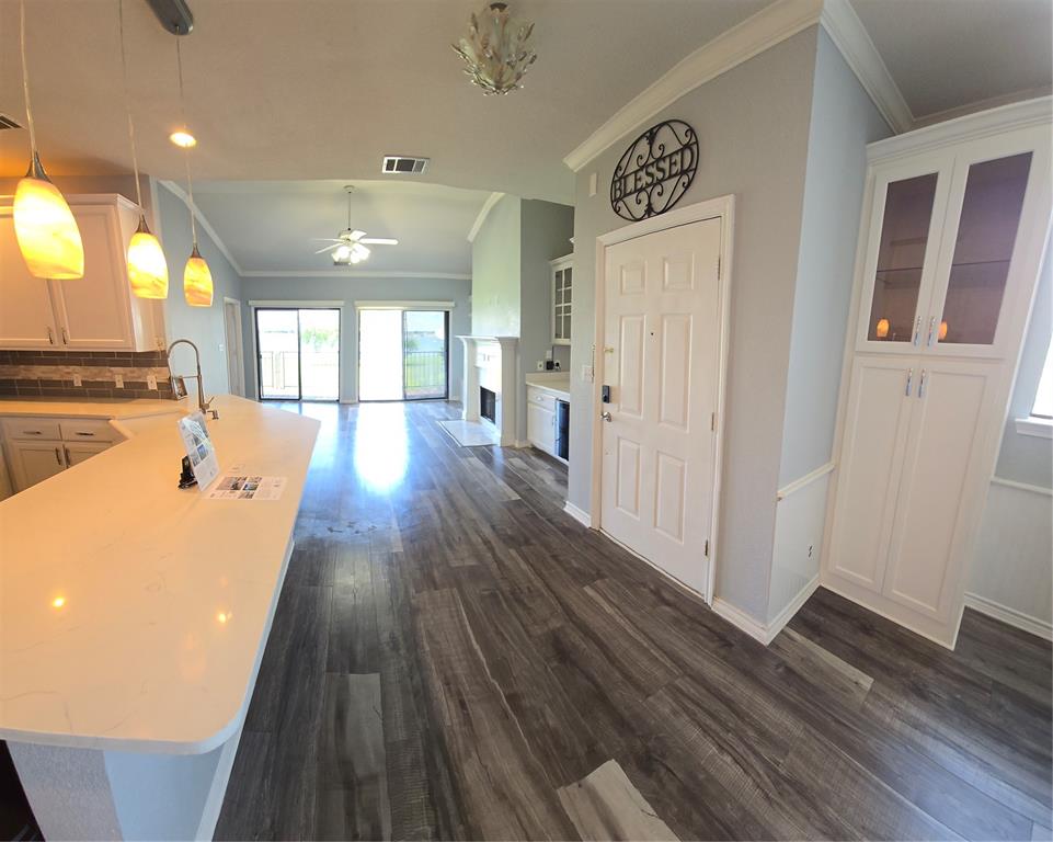 1904 Signal Ridge Place Rockwall, TX 75032 - Photo 9 of 23 Open-concept living area with wood-finish flooring extending throughout