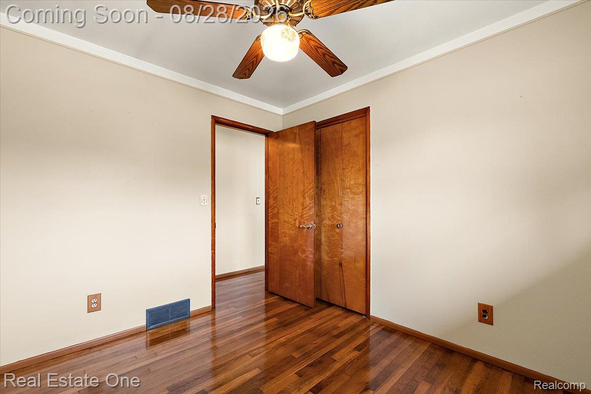 15250 34 Mile Road Armada, MI 48005 - Photo 36 of 49 Hardwood flooring, painted walls, ceiling fan with integrated lighting, and crown molding